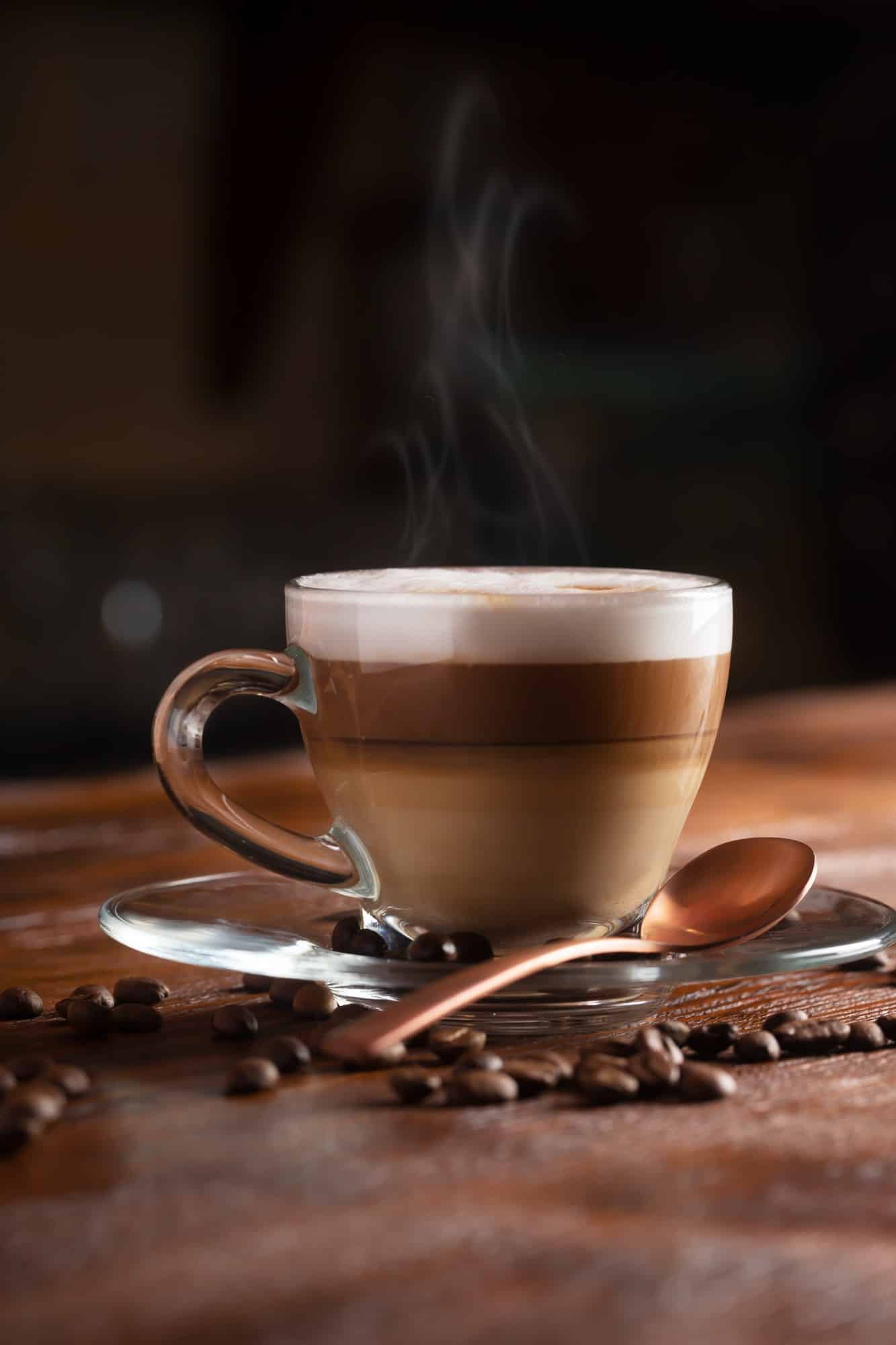 Cup of Coffe With Milk on a Dark Background. Hot Latte or Cappuccino Prepared With Milk